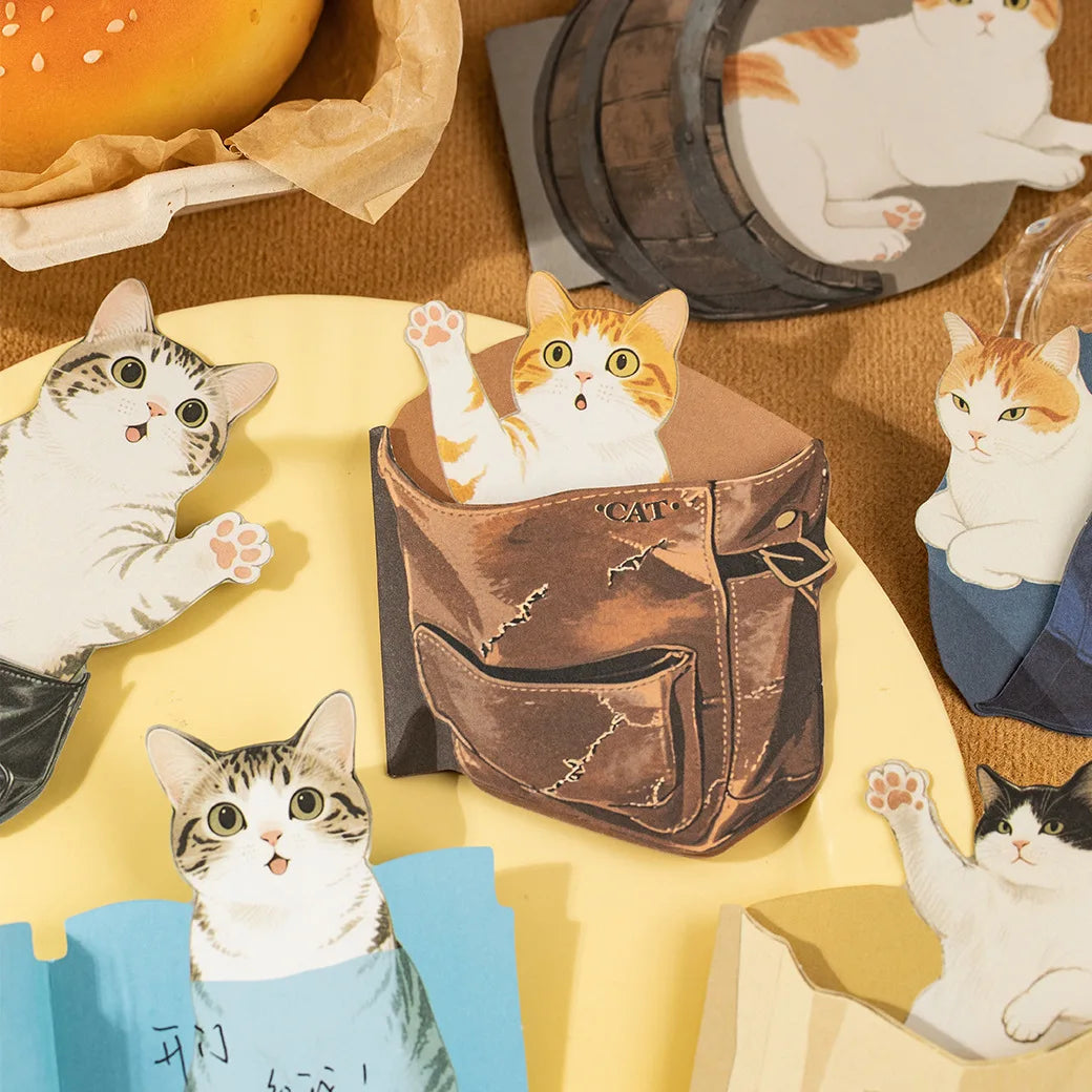 Sticky notes with illustrations of cats in various poses on a patterned background